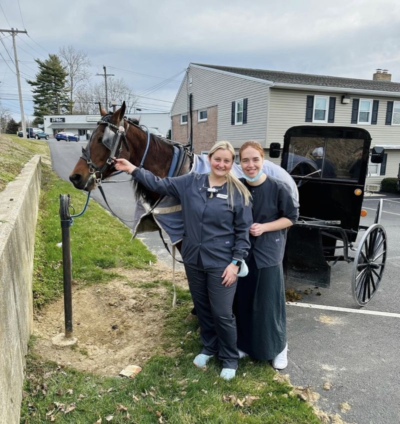 Hitching post in parking lot for horses.