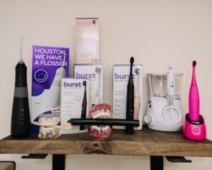 Shelf with electric toothbrushes, water flosser, and dental models