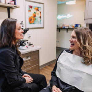 Dental team member speaking with patient during myofunctional therapy consultation