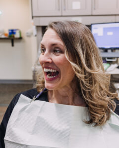 Patient showing teeth during myofunctional therapy evaluation