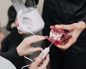 Demonstration of water flosser technique using dental model