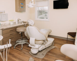 Clean, modern dental operatory with an empty chair and equipment ready for patient care