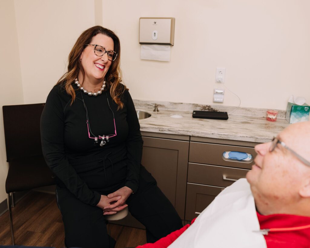 Dentist talking with a patient during a relaxed dental consultation