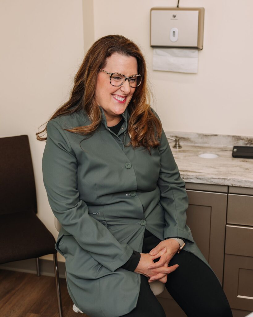 Dentist smiling and talking with a patient during a comfortable consultation