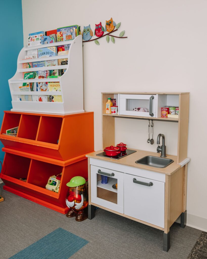 Children’s reading area with books in a kid-friendly dental office