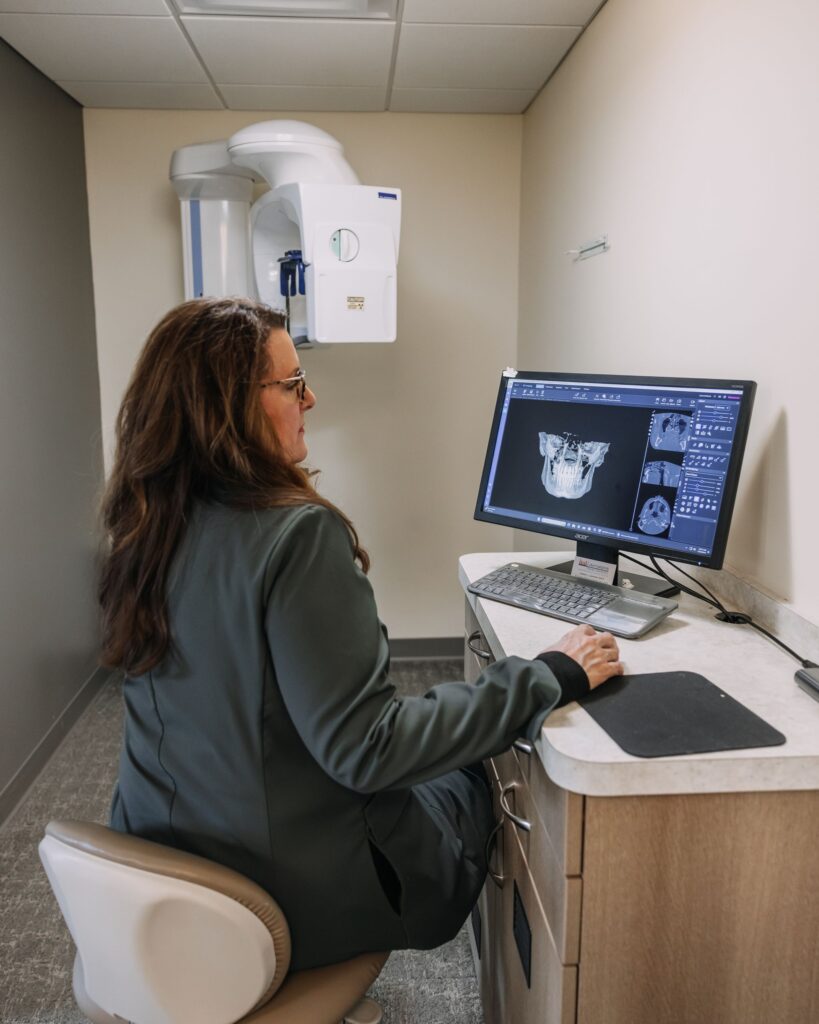Dentist reviewing 3D dental imaging used to diagnose root canal problems