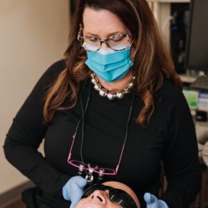 Dentist examining a patient during a dry mouth and oral health evaluation