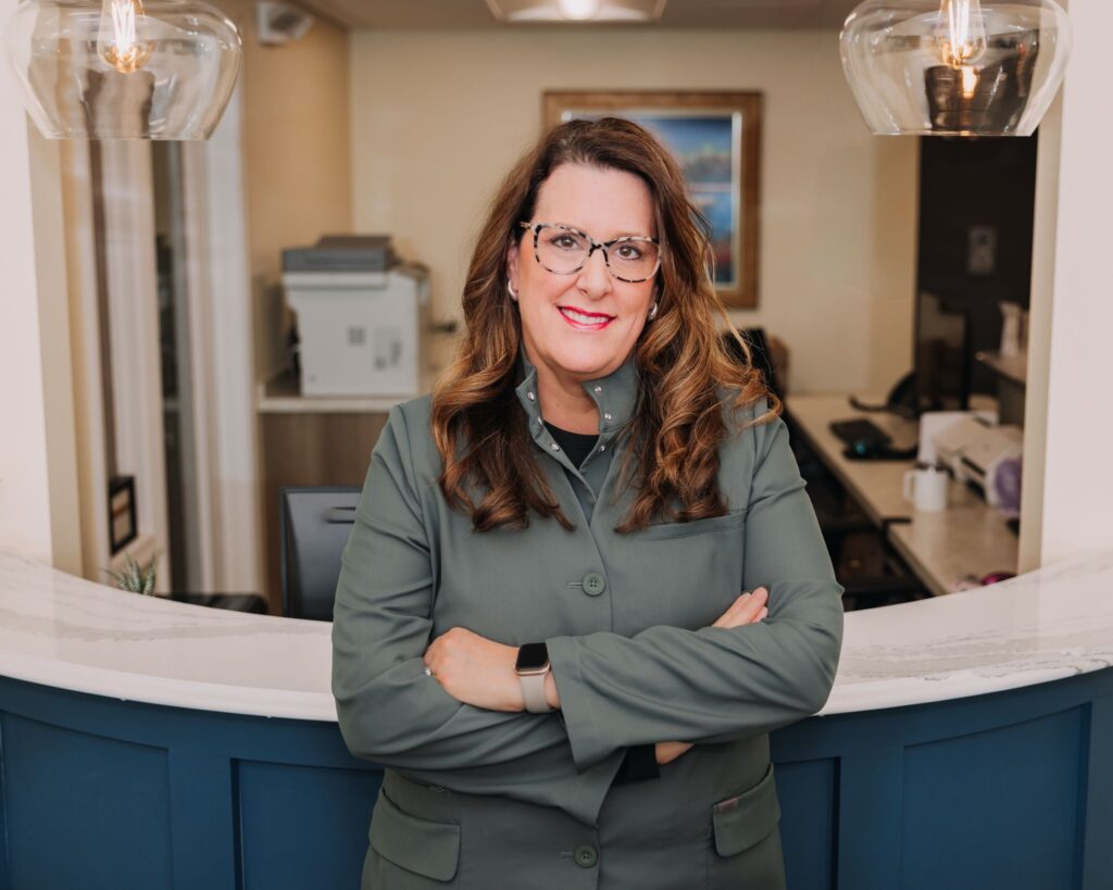 Dental office team member standing at the reception desk