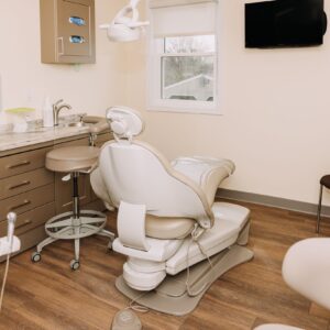 Dental treatment room with reclining chair and overhead light